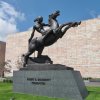 A statue of a Sioux warrior on a rearing horse, proposed and modeled by Serbian-born sculptor John David Brcin (1899–1983), realized by Matthew Placzek in the late 1920s for the entrance to the Joslyn Memorial.